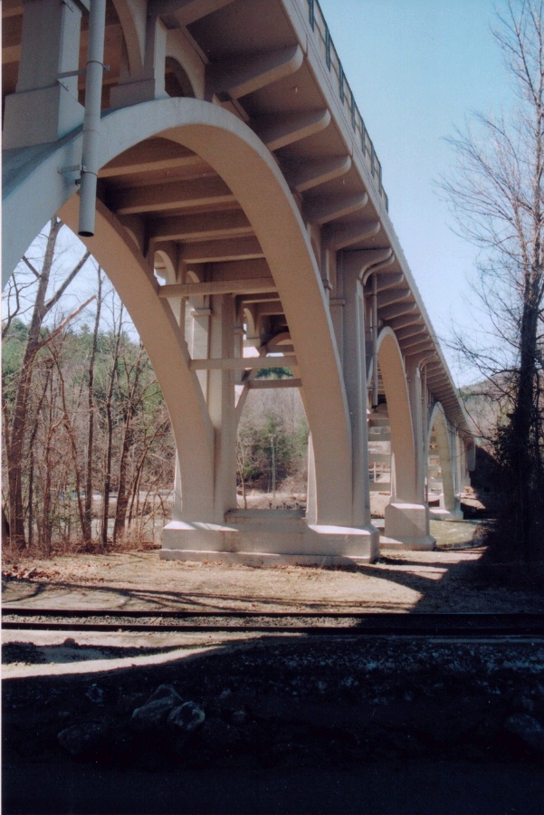 Underside of bridge, showing piers, arch ribs, and sidewalk brackets